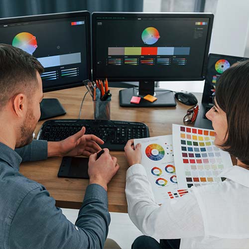  A graphic designer creating a professional brand identity on a modern computer monitor.